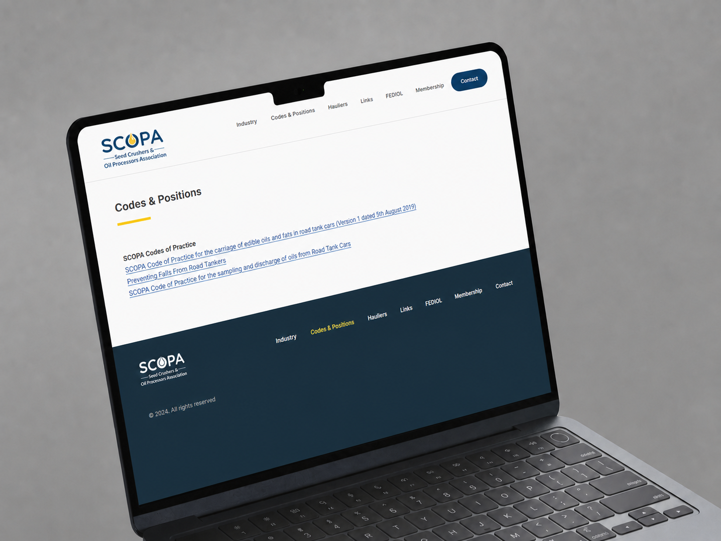 SCOPA About page presented on an iPad in a styled setting